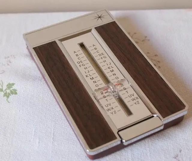 A sleek and elegant vintage flip open address index designed with wood paneling and metallic accents, once a staple for organizing contacts